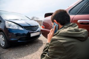 A man calling the police to report a car accident.