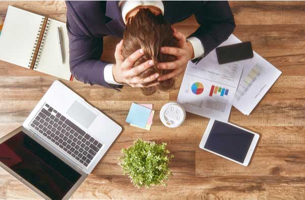 business man with head in hands work-related stress