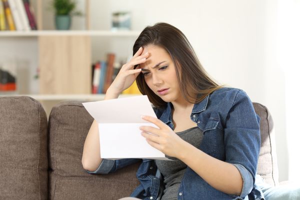 Woman reading denial letter for personal injury claim