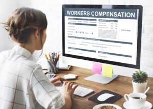 Woman Filling Out Workers' Compensation Claim Form