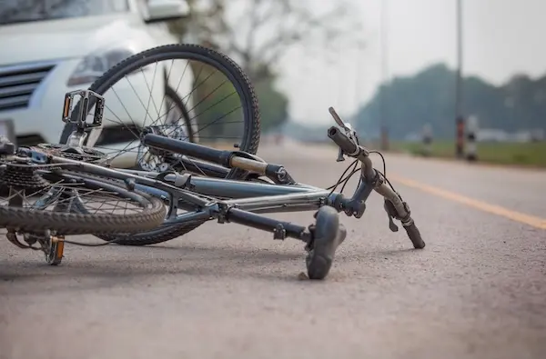 Damaged bicycle at the scene of a car versus bicycle accident