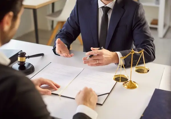 A bus accident lawyer speaking with a client