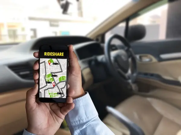 Rideshare app trip screen displayed in a vehicle to represent a rideshare accident lawyer reviewing a rideshare app.
