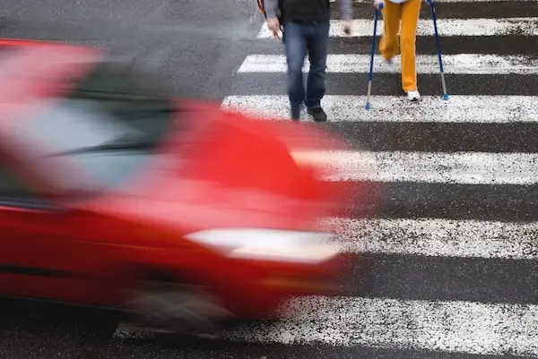 Pedestrian accident lawyer helping injured pedestrian after a crosswalk collision