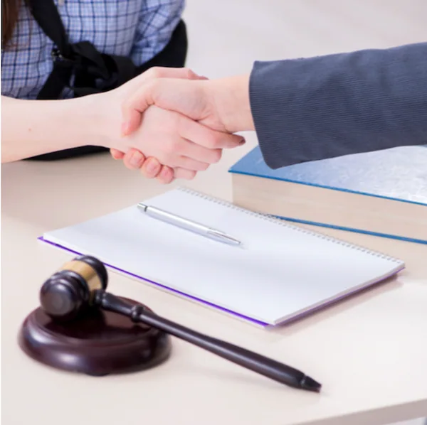 personal injury lawyer shaking clients hand after a successful case